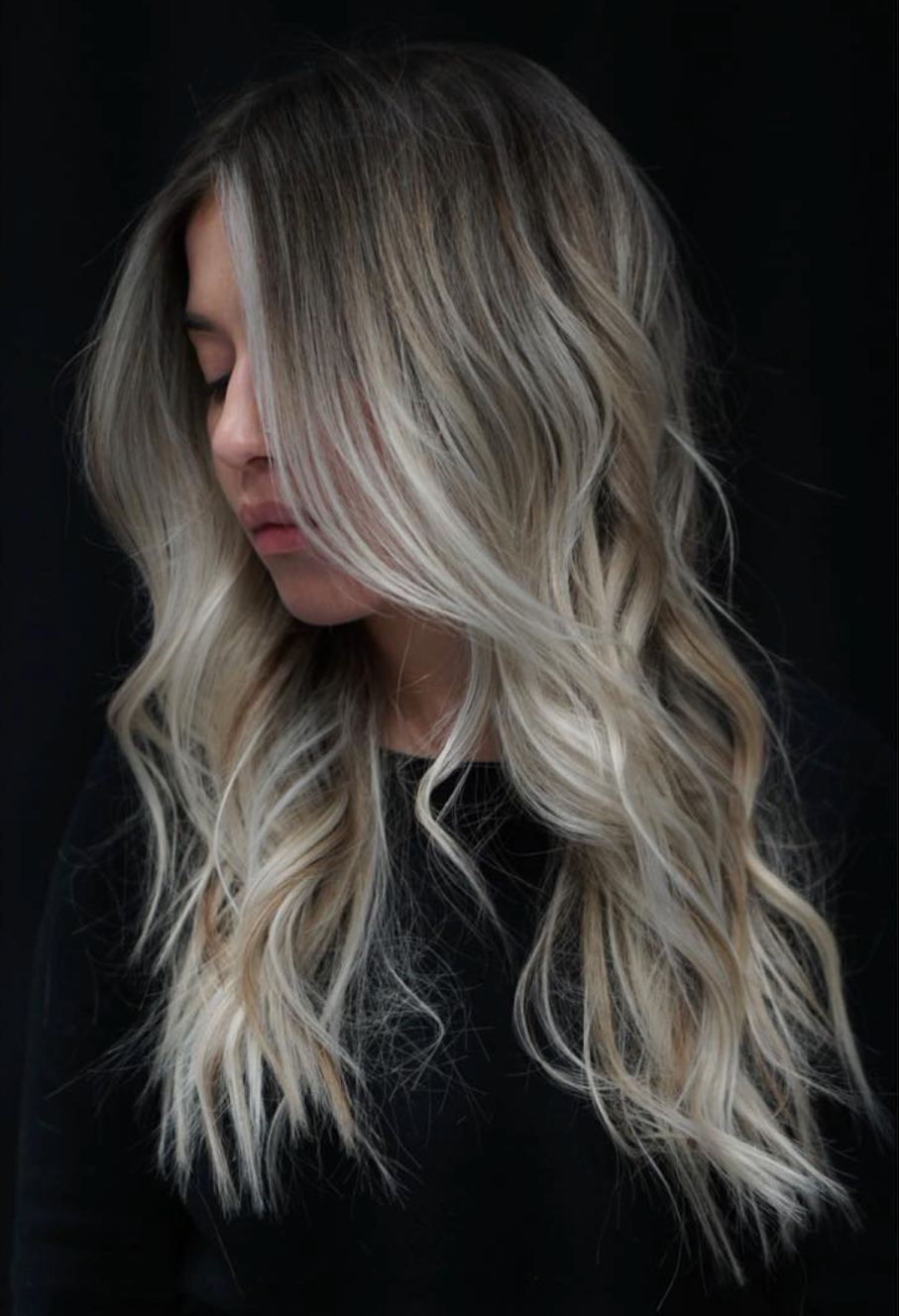 Cool-toned blonde waves against a dark backdrop