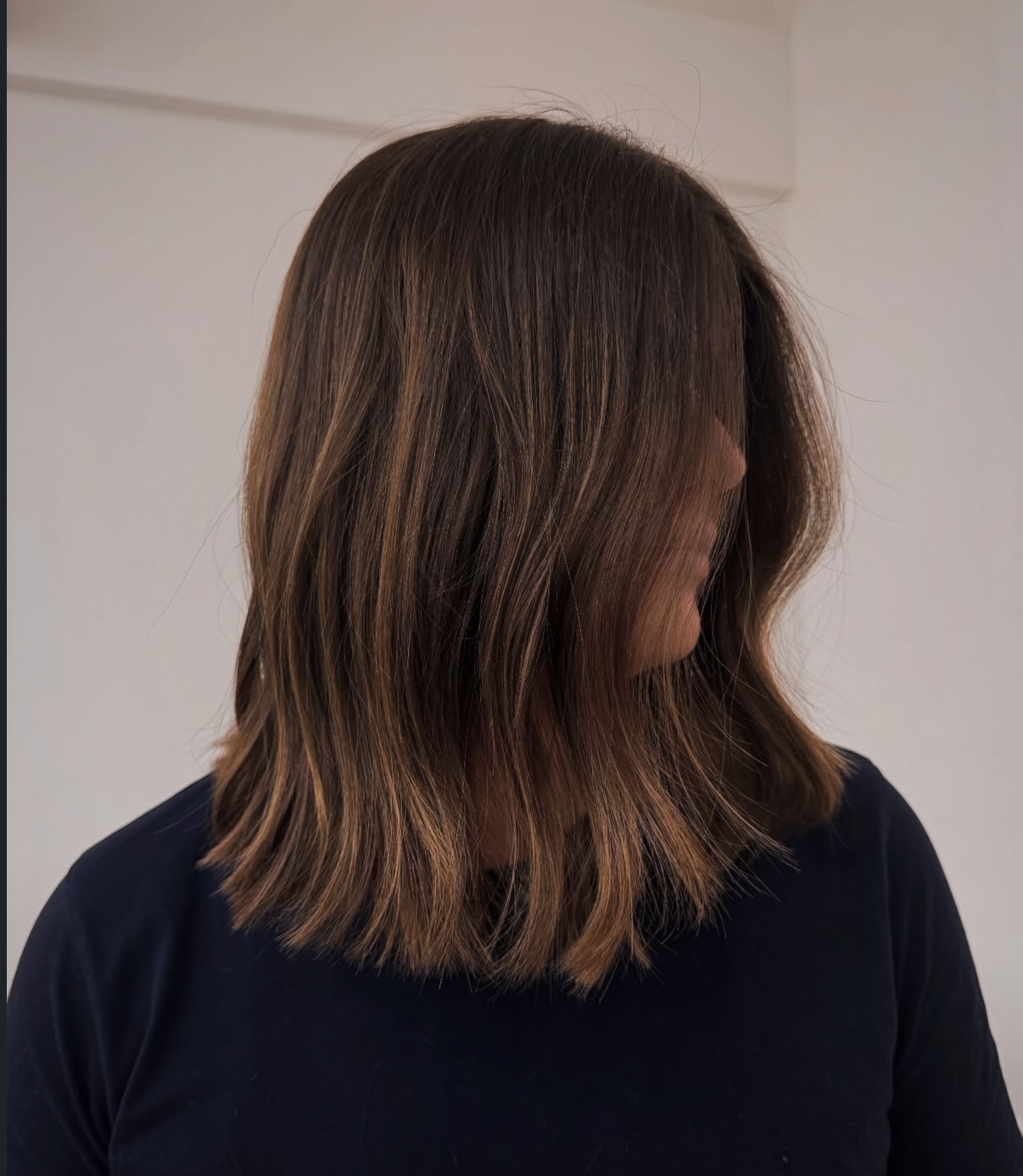 Soft brunette lob with subtle caramel dimension